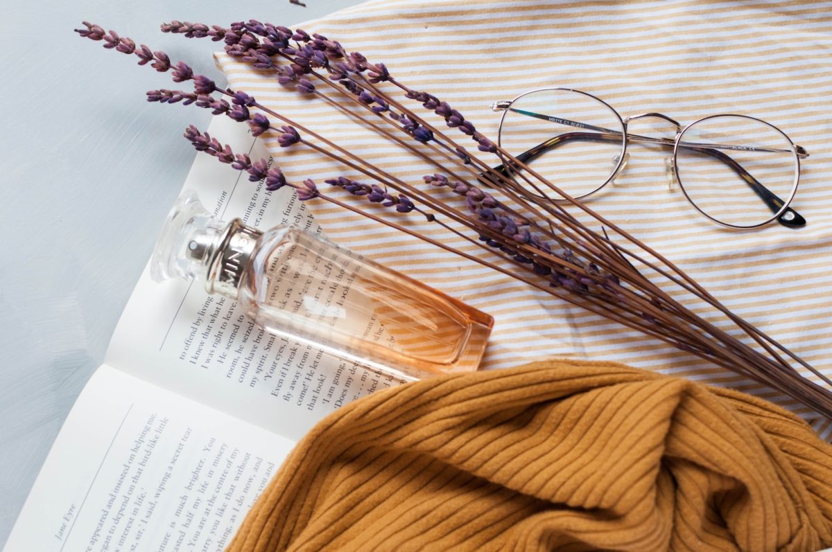 fragrance bottle, lavender, and eyeglasses