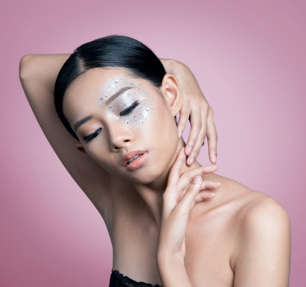 a woman with glitter on her face posing for a picture