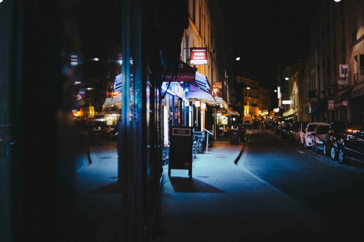 cars parked in front of stores during nighttime