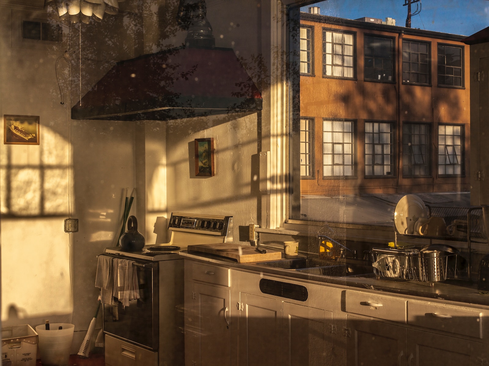 stainless steel sink beside brown wooden framed glass window